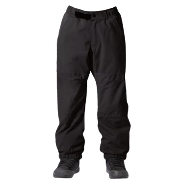 Black outdoor/hiking pants with elastic cuffs worn over dark sneakers, showing a full-length fit above the boots.