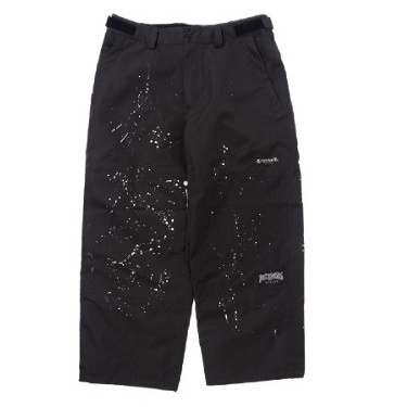 Black knee-length shorts with white paint splatter marks on the front and pockets