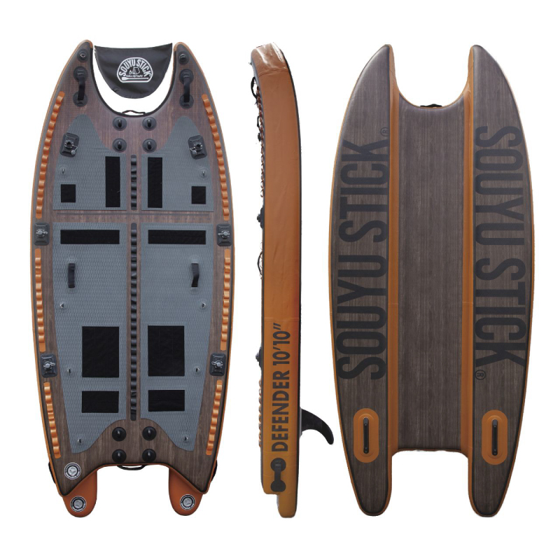 Three views of a wooden-style stand-up paddleboard: top deck with foot pads and straps, side view labeled 'Defender 10'10"', and bottom with bold 'SOULSTICK' branding.