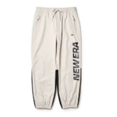 Beige jogger pants with drawstring waist and elastic cuffs, featuring a vertical'NEW ERA' logo along the leg.