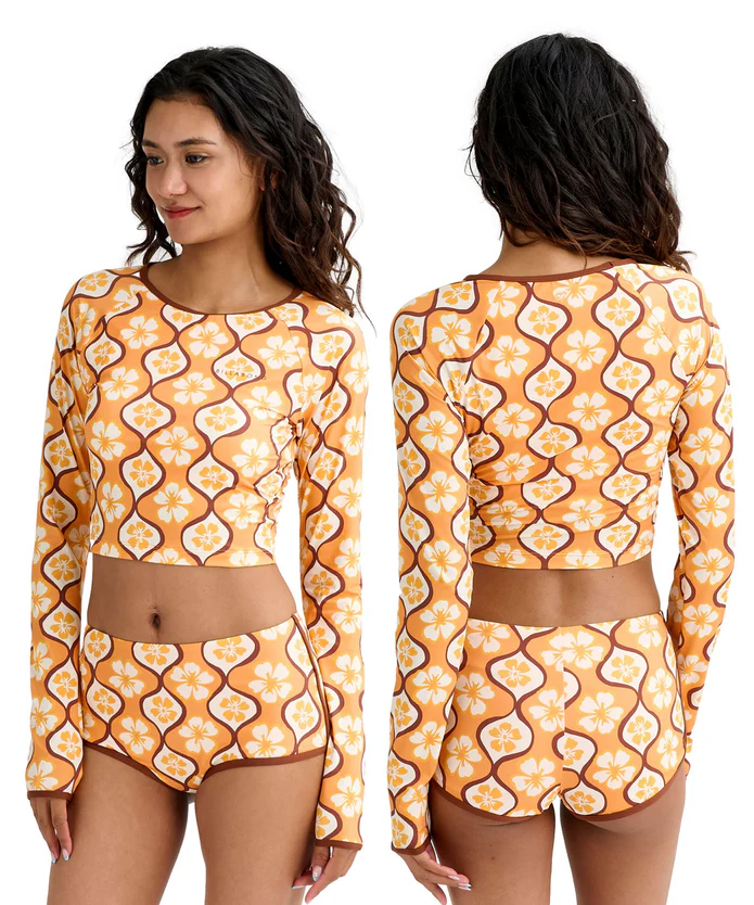 Front view: model wearing a long-sleeve cropped top and matching high-waisted bikini bottoms in an orange floral print.