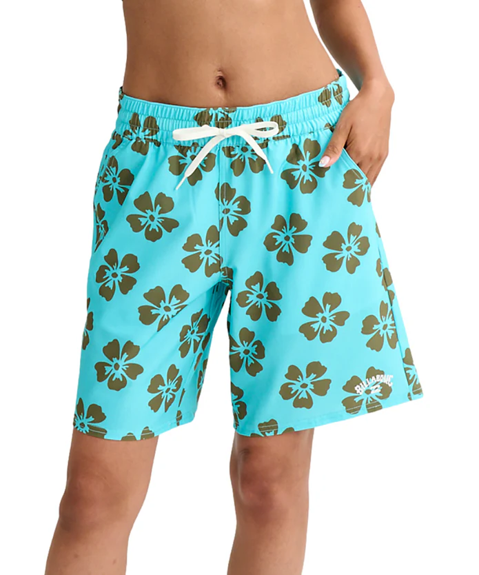 Turquoise boardshorts with brown hibiscus floral pattern and a white drawstring, worn by a model midsection view