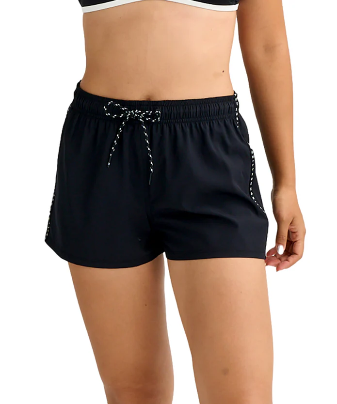 Woman wearing black athletic shorts with a white-dotted drawstring, midsection visible