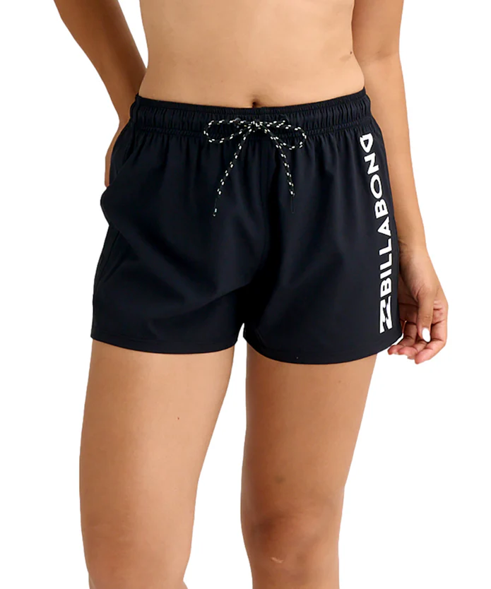 Person wearing black drawstring athletic shorts with Billabong logo running down the side of the right leg.