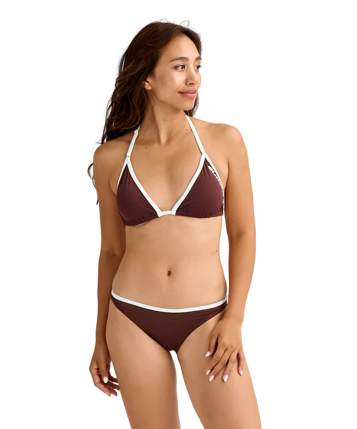 Woman modeling a brown bikini with white trim, standing and looking to the right.