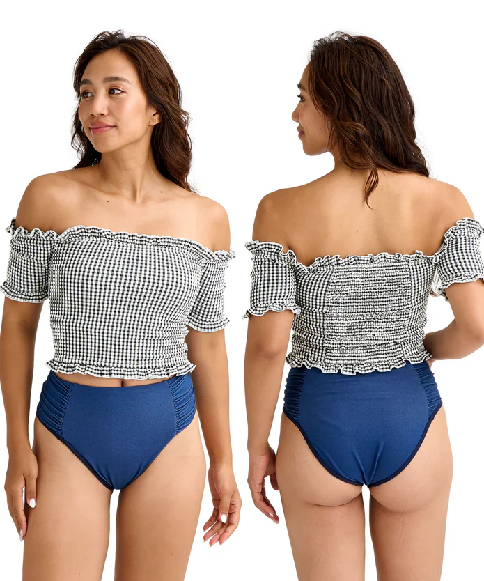 Front and back view of a woman wearing a black-and-white gingham off-shoulder swimsuit top with ruffles and blue high-waisted bikini bottoms.