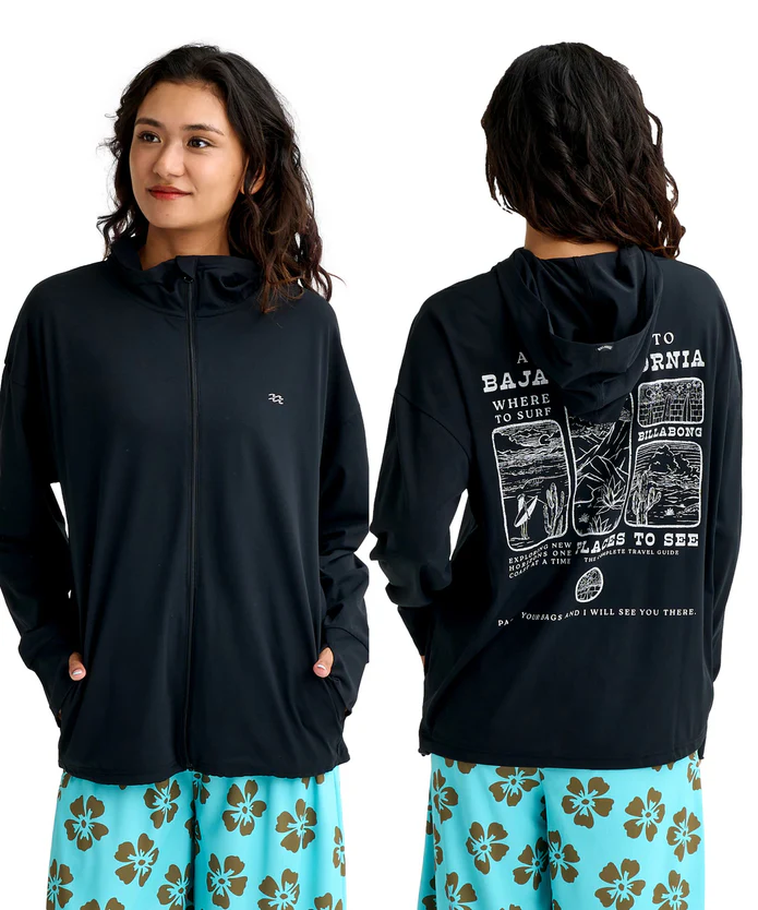 Woman wearing a black zip-up hoodie, front view with hands in pockets; back view shows a white graphic print and text on the hoodie, paired with teal hibiscus-print shorts.