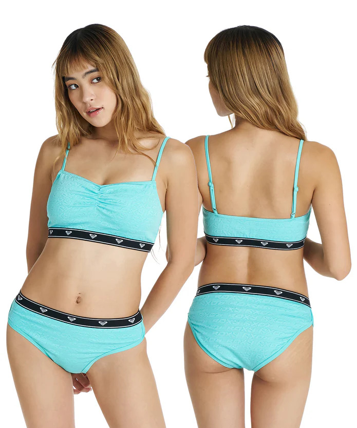 Two-view shot of a turquoise bikini set on a model, front and back, with a black logo waistband.