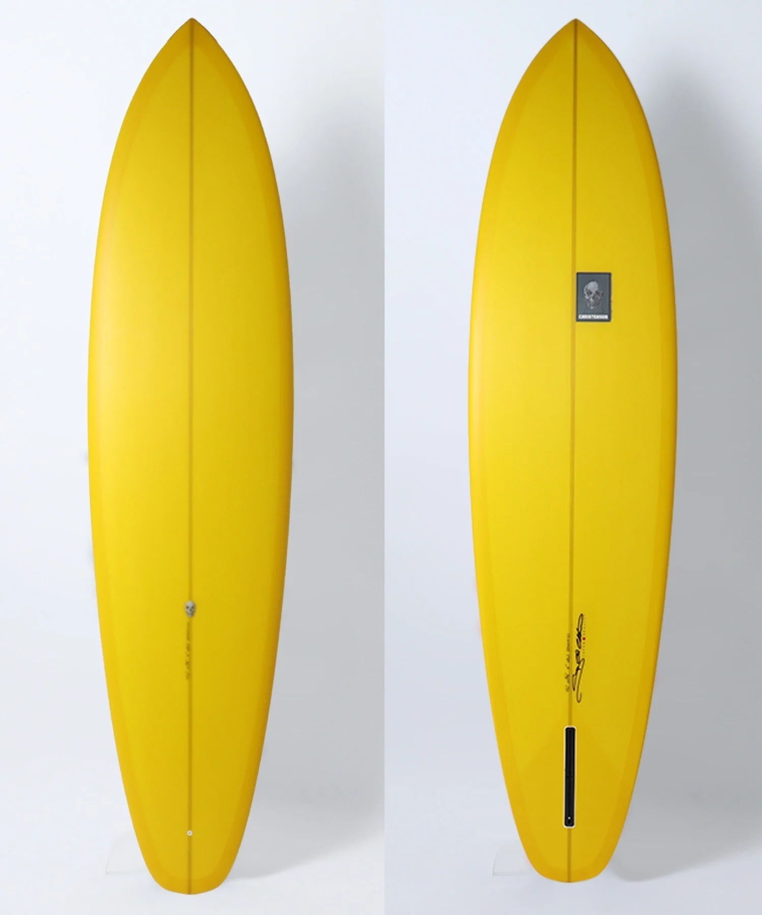 Yellow surfboard with a central seam, shown from two angles; the right image has a small logo sticker mid‑board.