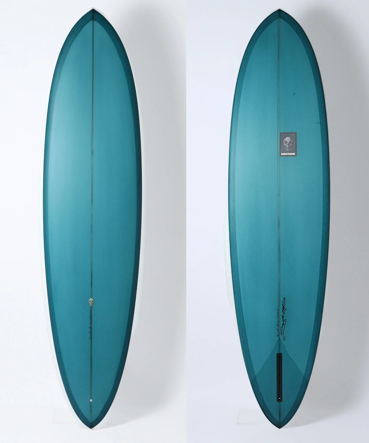 Two teal surfboards shown side by side against a white background; left is a front view, right is the back view with a small logo sticker.