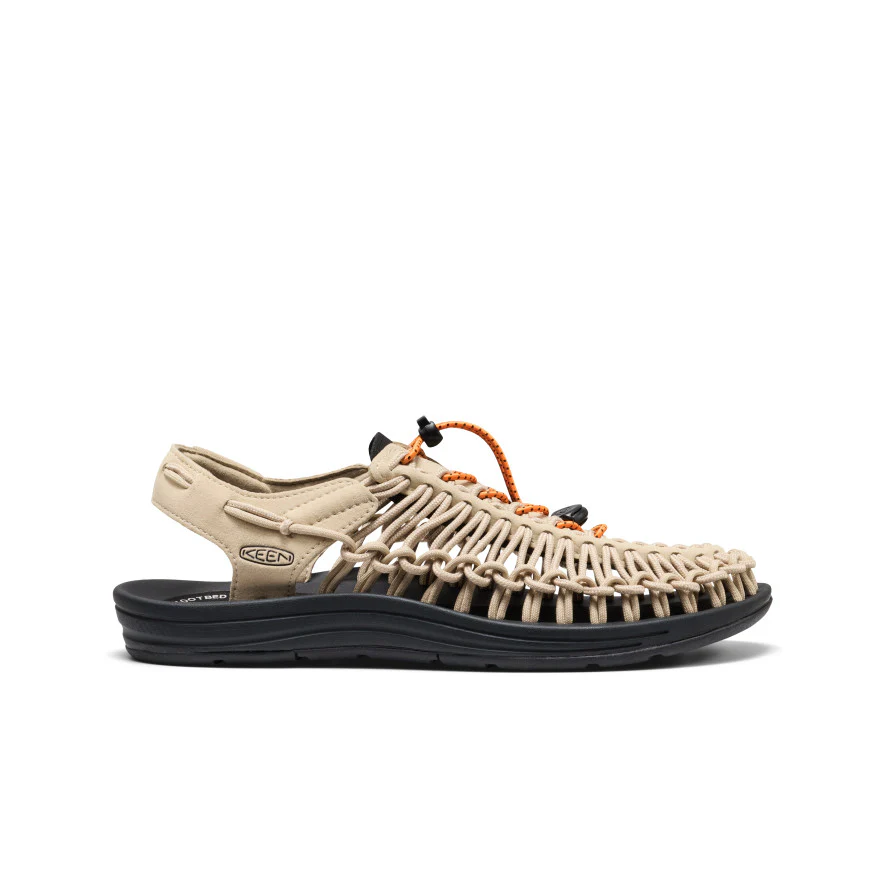 Beige outdoor sandal with a woven upper and orange bungee laces, black rugged outsole