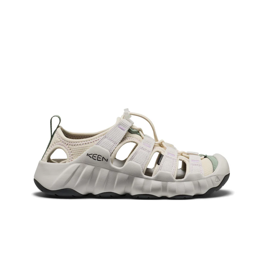 Beige KEEN outdoor sandal with multiple straps, cutout sides, and a rugged black sole.