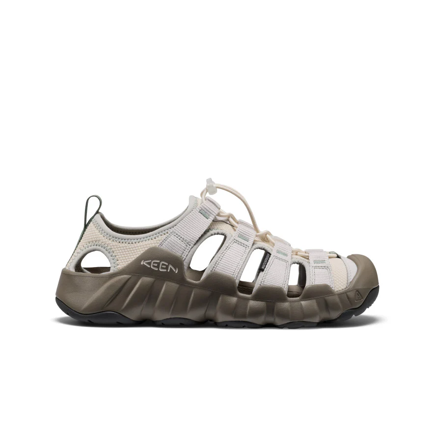 Beige KEEN outdoor sandal with closed-toe design, multiple straps, and a rugged brown sole.