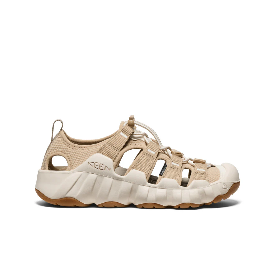 Beige KEEN outdoor sandal with woven straps and a chunky white sole.