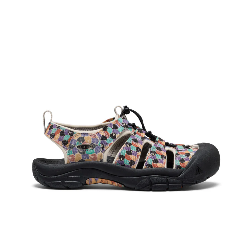 Colorful outdoor sandal with a closed-toe rubber cap, black rugged sole, and multicolored checkered fabric straps.