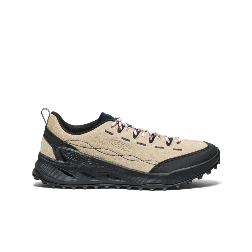 Beige Keen hiking shoe with black sole, pink laces, and navy accents viewed from the side.