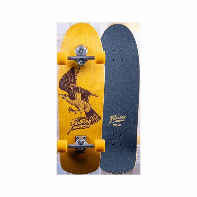 Two longboards standing upright side by side: a bright yellow board with an eagle graphic and yellow wheels, and a dark blue board with grip tape and a small logo