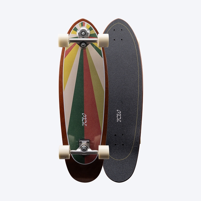 Two longboards shown side by side: one with a multicolor retro chevron design and white wheels, the other with a gray grip-taped surface and amber edge.