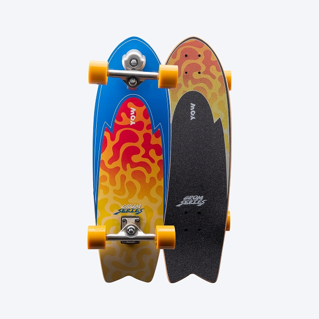 Two skateboards with bright graphics and yellow wheels, stacked closely together against a light background (one blue with red-orange flame pattern and one dark with orange gradient and grip tape).