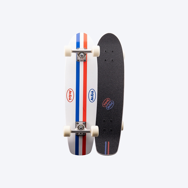 Two skateboards standing upright side by side: one white with red and blue stripes, the other black with grip tape and a logo