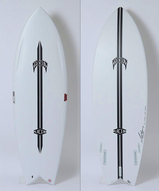 Two white surfboards stand upright side by side, each featuring a bold black vertical sword graphic and subtle logos along the shaft.