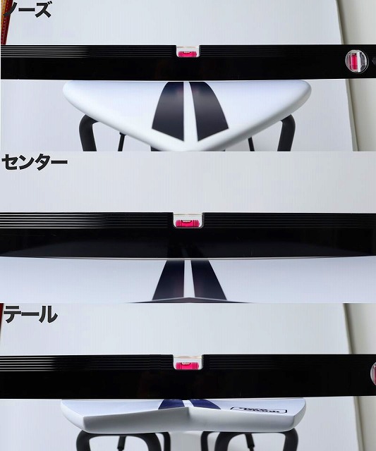 Close-up of white chair shells with black rails and pink latches, arranged in a row, showing the seat and backrest pieces.