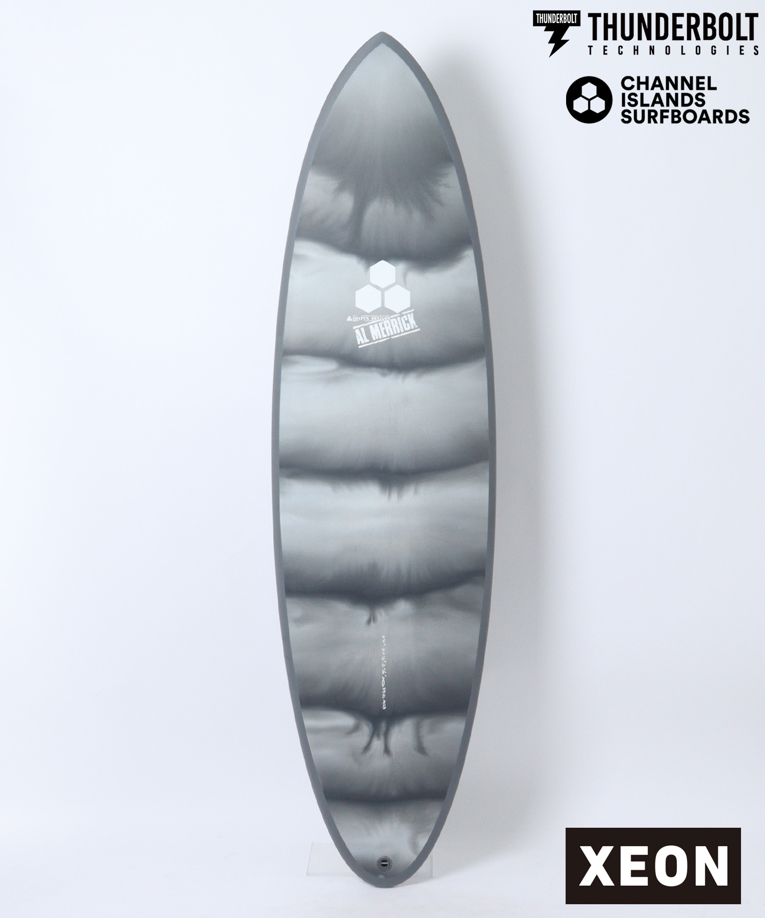 n22821101010002 - SHOP NEWS | ムラサキスポーツオンラインストア 通販 Grey surfboard fin with a white hex logo and 'AL MERRICK' text; Thunderbolt Technologies and Channel Islands Surfboards logos in the top-right, plus a black XEON label in the bottom-right.