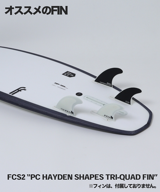 White surfboard deck with a black edge displaying a four-fin FCS2 Hayden Shapes Tri-Quad fin setup: two large black fins at the tail and two smaller translucent fins, fins pictured but not included; Japanese text reads 'Recommended fins' and product name is 'FCS2 “PC Hayden Shapes Tri-Quad Fin”'