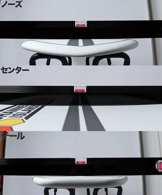 Close-up of a white curved handle between black rails with pink tabs, with Japanese labels for Nose, Center, and Tail-like terms visible.