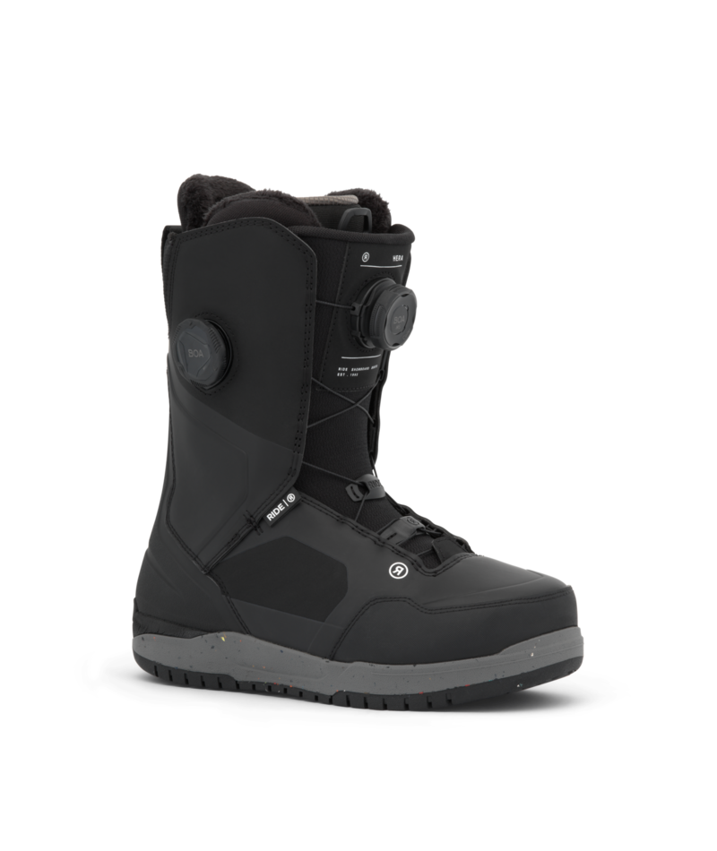 Black snow boot with a BOA dial fastening system and rugged gray sole, mid-calf height, shown in profile view for product showcase.