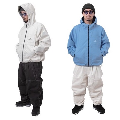 Two men model lightweight windbreakers: white hooded jacket with black pants on the left, and blue hooded jacket with light cream pants on the right.