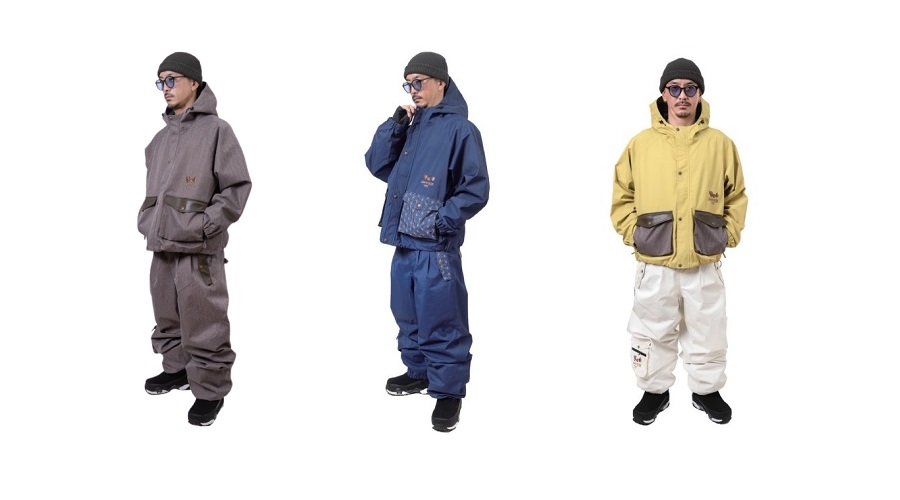 Three men modeling color‑coordinated winter snowsuits: brown on the left, blue in the middle, yellow on the right, each with hoods and cargo pockets.