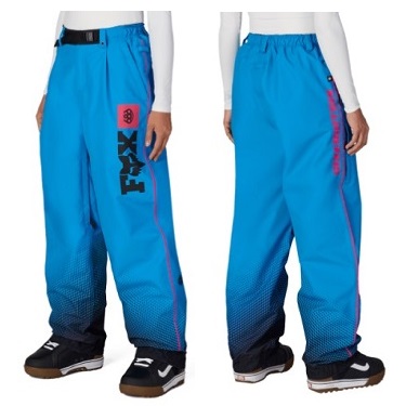 Front and back view of bright blue Fox snow pants with gradient dark hem, pink piping along the side, and a vertical Fox logo on the left leg. Sleeves and shoes visible for scale.