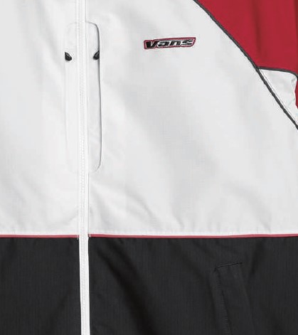 Close-up of a color-blocked Vans windbreaker: white upper panel, black lower panel, red trim, and a zipper in the center.