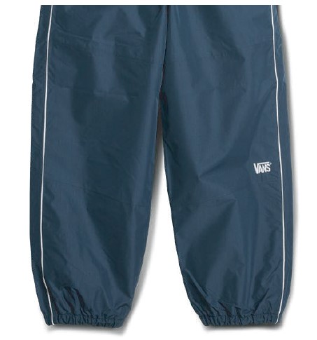 Navy blue windbreaker pants with white piping along the sides and elastic cuffs; Vans logo on the right thigh.
