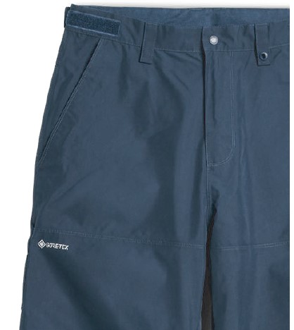 Close-up of navy blue Gore-Tex outdoor pants at the waist showing belt loops, zipper fly, and side pocket with the Gore-Tex logo visible.