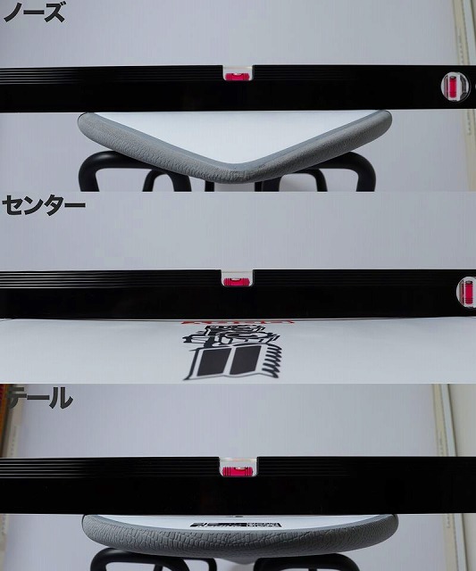 Product photo of a bicycle saddle shown in three horizontal segments, labeled in Japanese as 'Nose', 'Center', and 'Tail', with a gray saddle mounted on black rails and pink alignment markers against a white background.