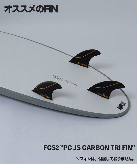 Surfboard fins on a white board; three black carbon FCS2 tri-fin setups with the label FCS2 'PC JS CARBON TRI FIN' visible within the image.