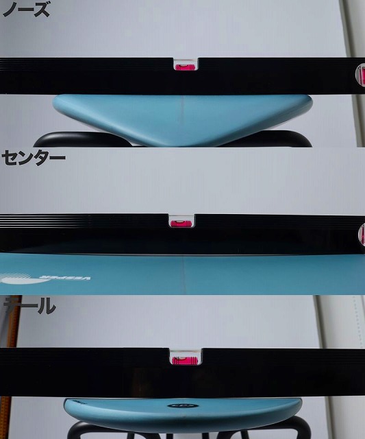 Display showing sections of a surfboard (nose, center, tail) labeled in Japanese, with blue boards on display.