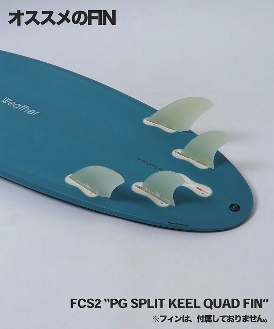 Blue surfboard tail showing four translucent split-keeled FCS2 quad fins installed at the tail, with product label nearby.