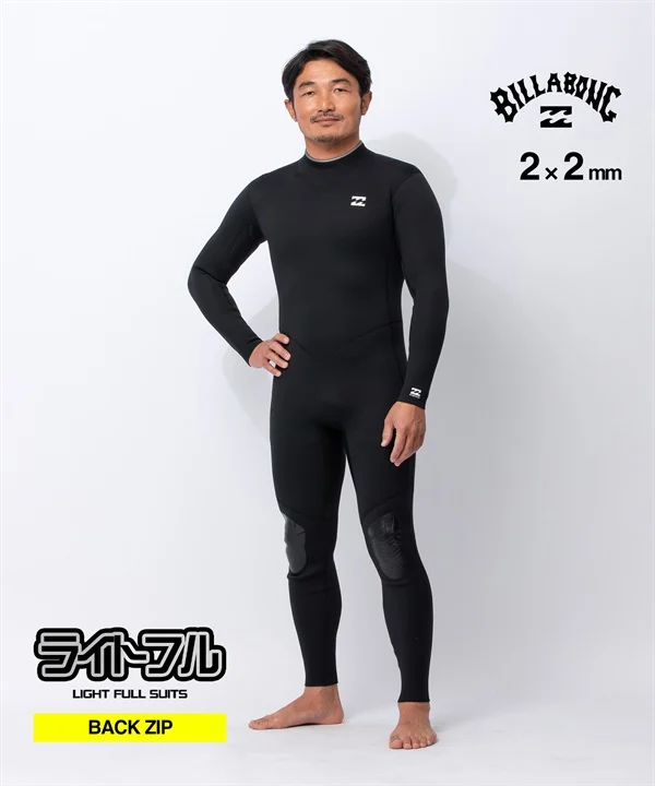 Man wearing a black full-body wetsuit with back zip, standing with one hand on hip; Billabong logos on chest and wrist, kneepads visible in studio lighting, with 'Back Zip' label in the image.